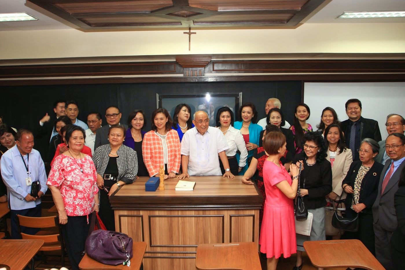 Guests gathered around the lectern in the Rosales Room